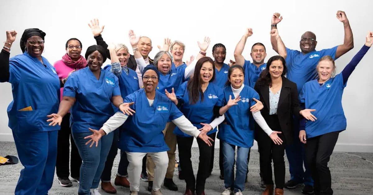 Group photo of nurses and healthcare team members smiling and celebrating for the Aged Care Nursing Seminar